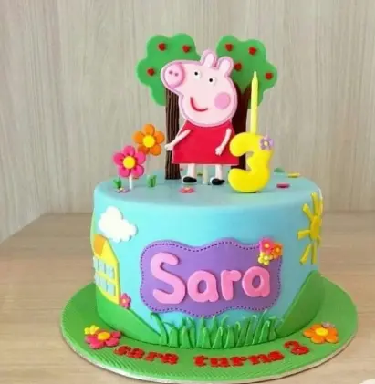 Cartoon Cake from the best bakery cakes shop in Aligarh, colorful kids theme cake with cute cartoon figure, name Sara, flowers, trees and number 3 topper